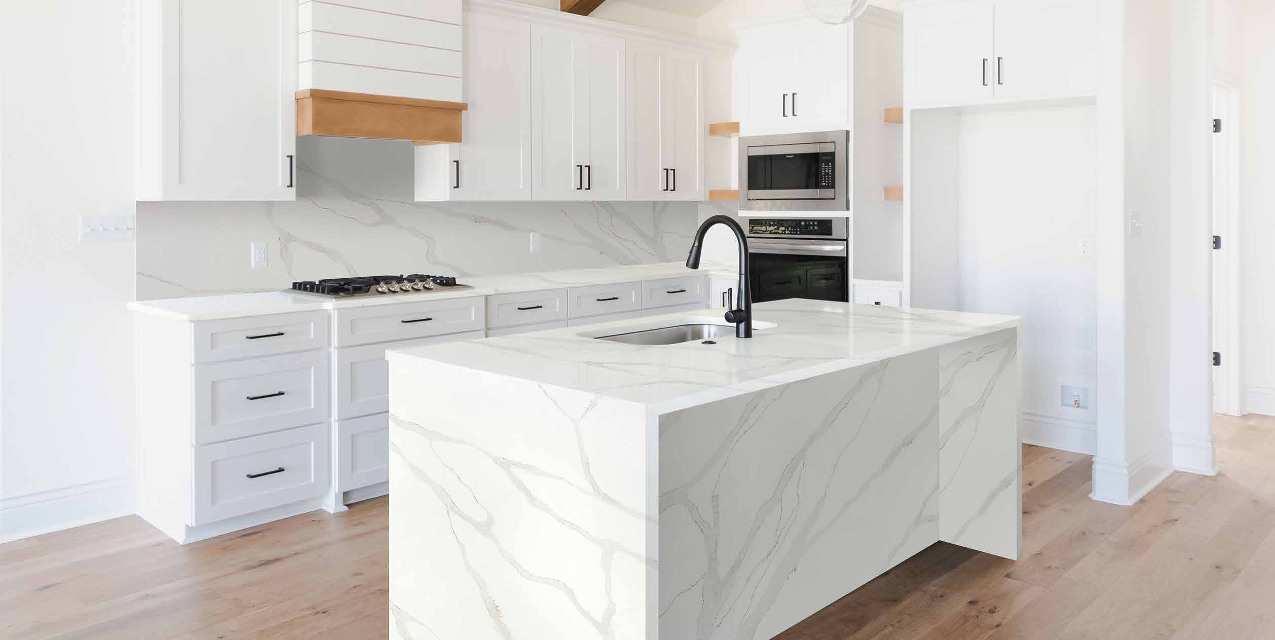 Modern white shaker kitchen with a marble island